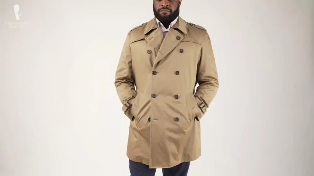 Kyle wearing a double-breasted brown trench coat