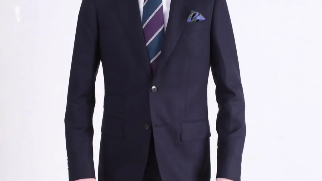 Navy suit with the middle button closed.