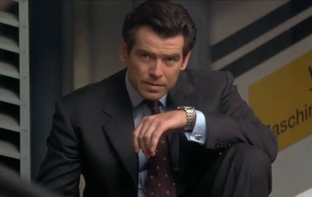 Pierce Brosnan as James Bond in Tomorrow Never Dies, wearing a charcoal worsted flannel suit.