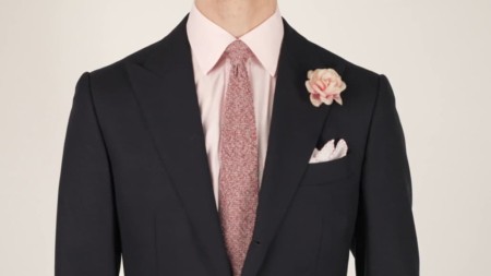 Preston wearing a magenta pink tie and gray cri de la soie silk from along with a linen pocket square that is pale pink. He also opted for a powdery pink rose boutonniere.