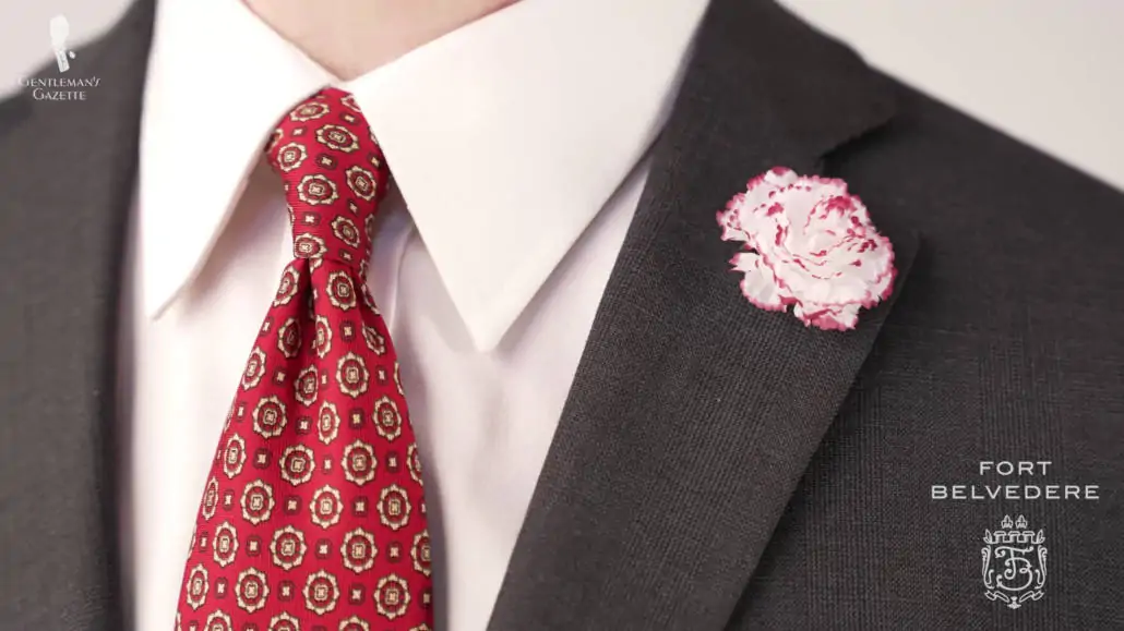 Preston showing his mini carnation boutonniere and his red madder silk geometric pattern.