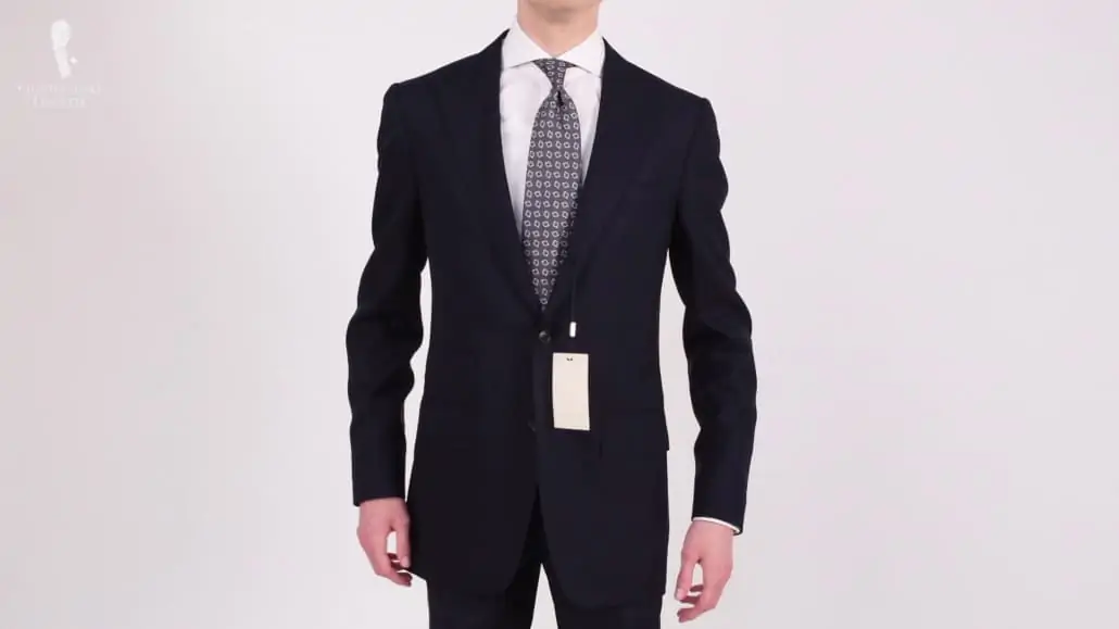 Preston wearing a single breasted jacket with a grey printed tie.