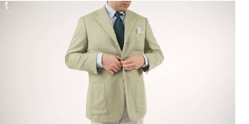 Raphael closing his sport coat in a three-roll-two fashion