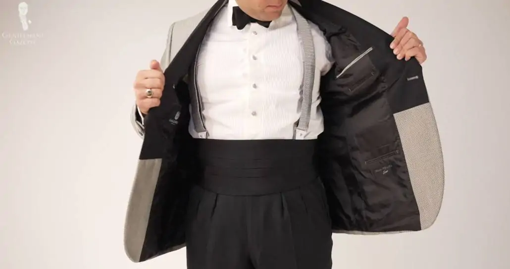 Raphael in a black tie ensemble flaunting his cummerbund.