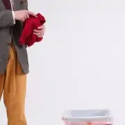 Raphael throwing a garment to a trash bin.