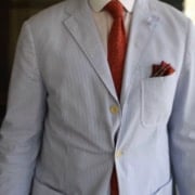 Raphael Wearing A Seersucker Suit That Drapes Poorly And Is Wrinkled Raphael wearing a seersucker suit that drapes poorly and is wrinkled.