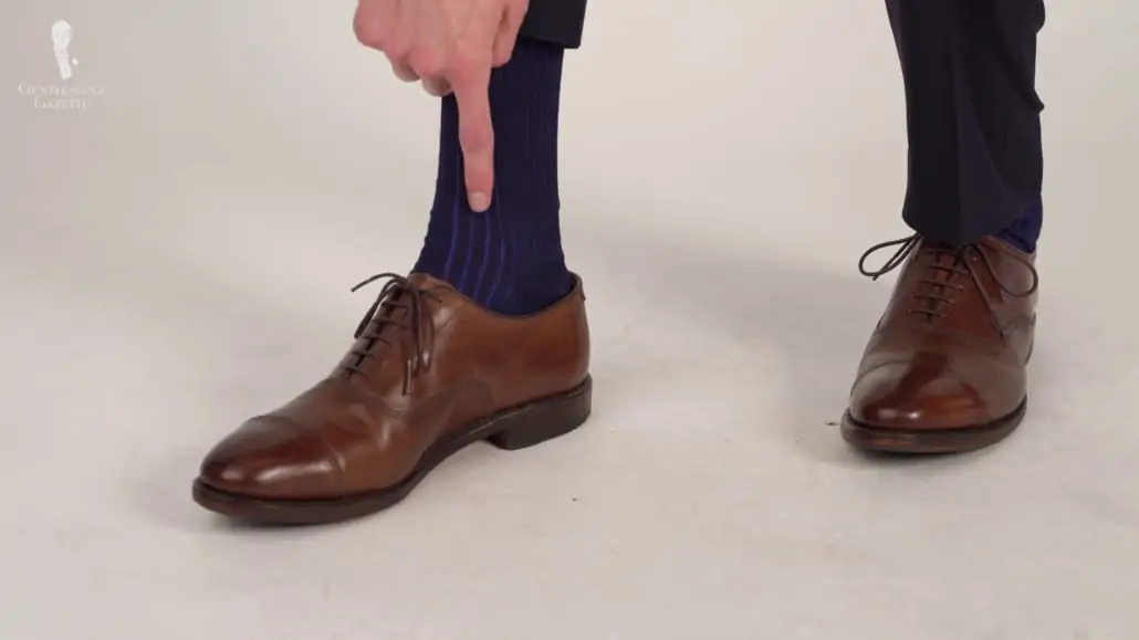 Preston wearing a shadow-stripe dress socks in navy blue and royal blue from Fort Belvedere