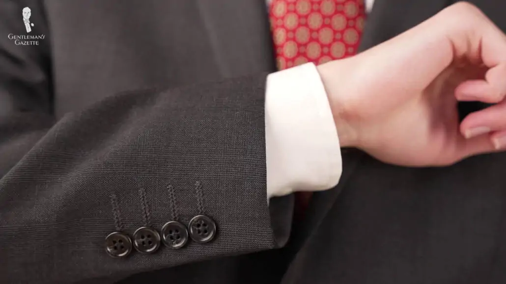 The four-buttoned cuffs of Preston's suit.