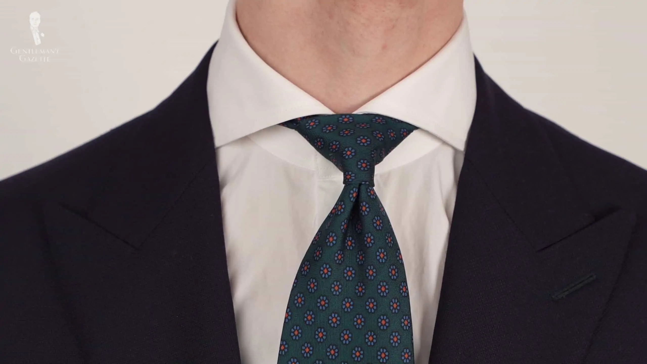 White shirt with wide spread collar paired with a madder silk tie in bottle green Macclesfield.