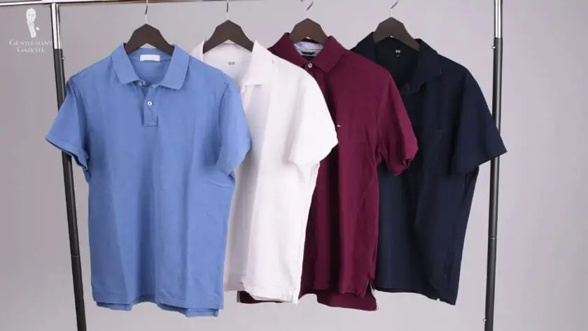 A rack of multi-colored polo shirts.