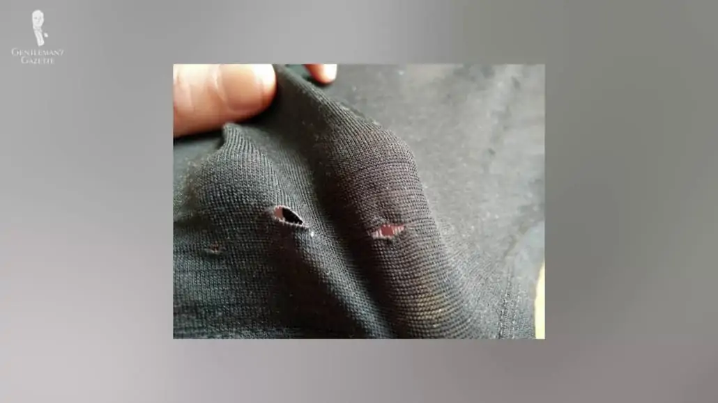 Hole on a black garment.
