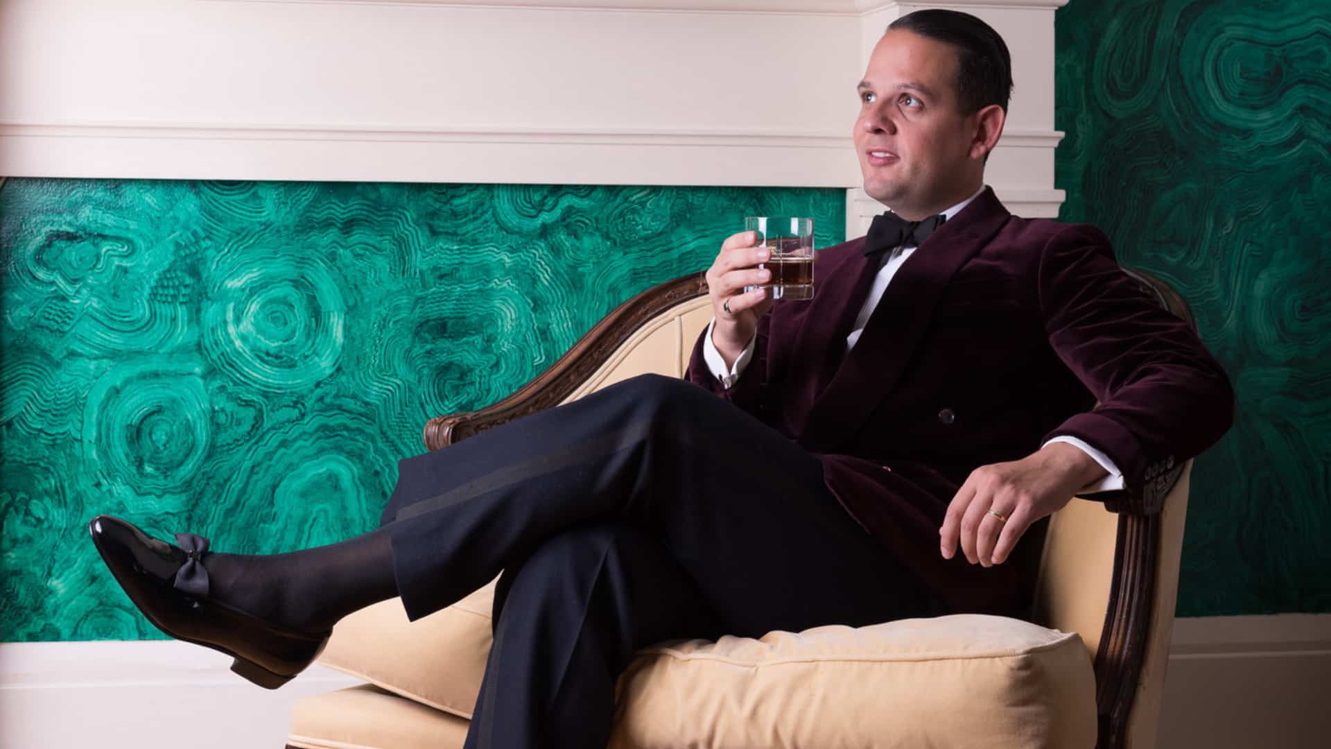 Raphael relaxs at home in a red velvet dinner jacket and midnight blue trouers