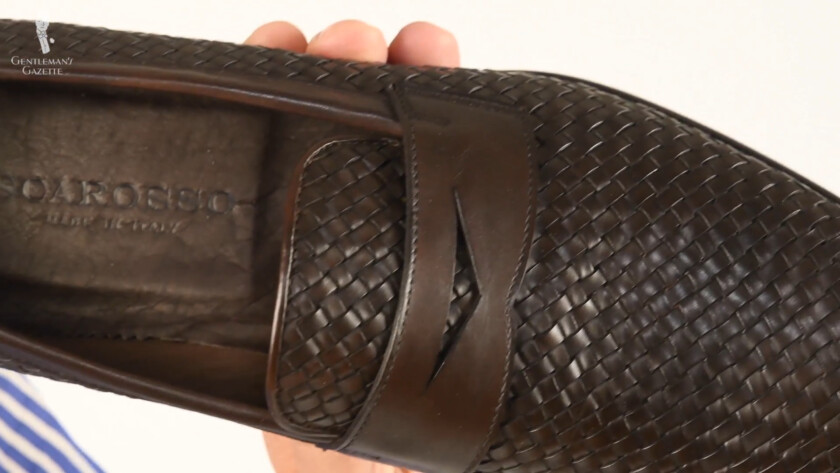 A close-up view of Raphael's chocolate brown Scarosso woven loafers.