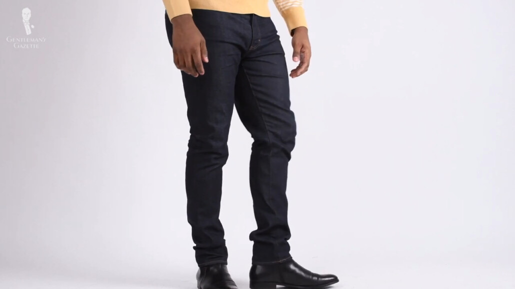 Kyle wearing close-fitting dark jeans with black boots.