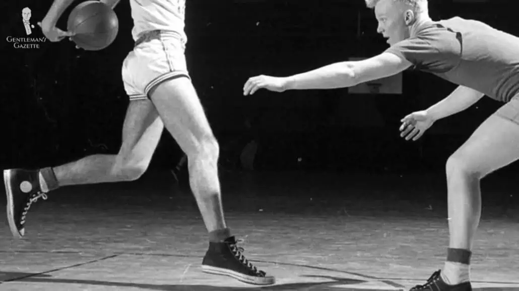 Charles “Chuck” Taylor wearing a pair of Converse while playing basketball.