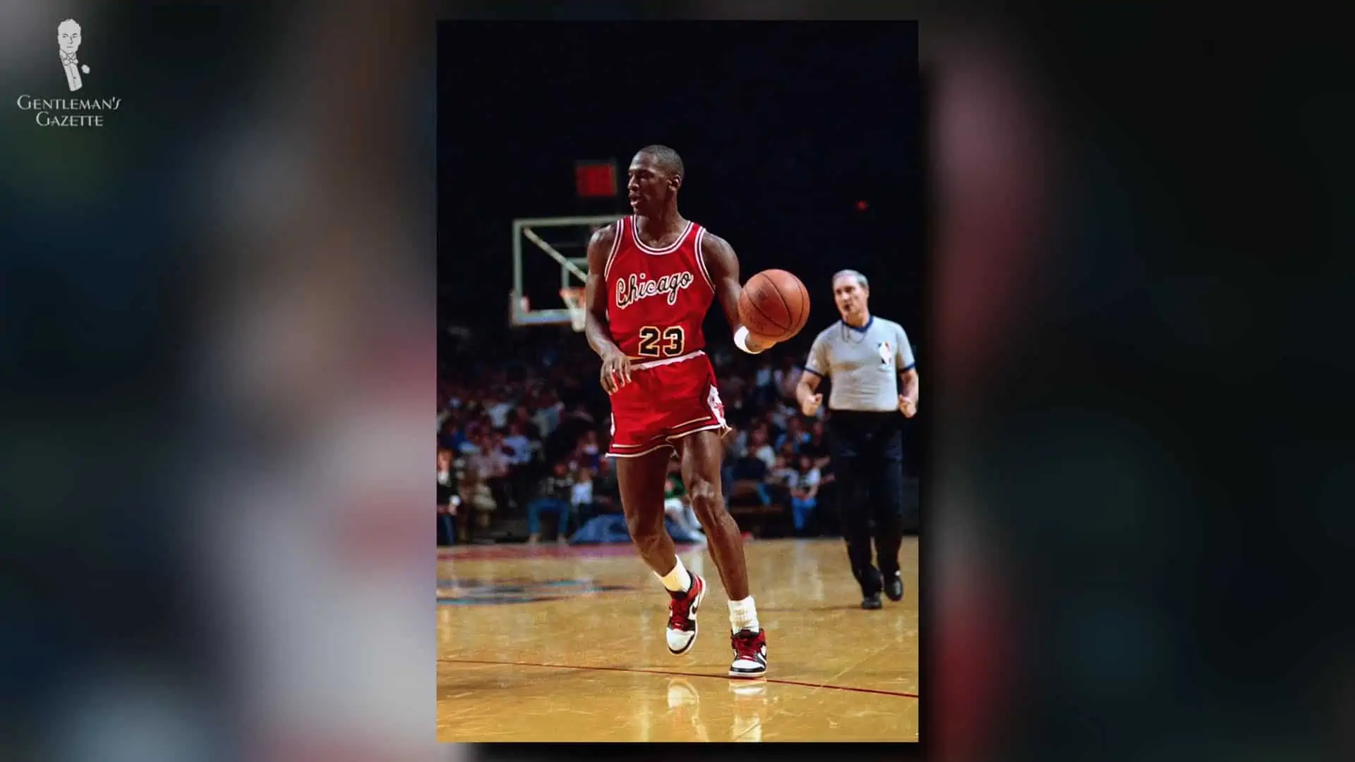 Michael Jordan wearing a pair of red and white Nike Air Jordans while playing basketball.