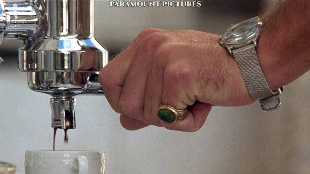 A close-up look at Dickie’s pinky ring with a green stone and his Swanson 30-meter quartz watch.