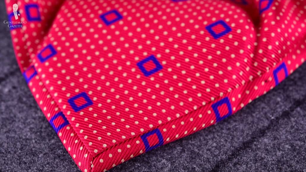 A red, printed, tipped tie.