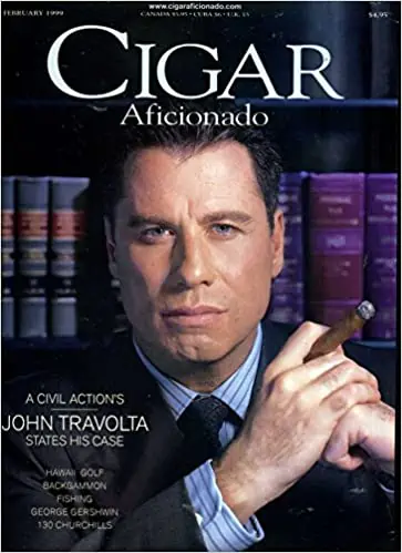 A photograph of the cover of Cigar Aficionado magazine, featuring John Travolta
