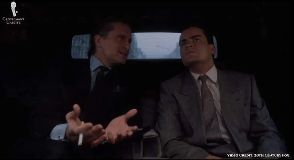 Fox in an upgraded ensemble: a gray double-breasted suit, a pink shirt, and a purple and blue silk paisley tie.