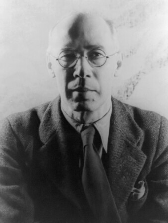 A photograph of Henry Miller, an older white man in a suit and glasses