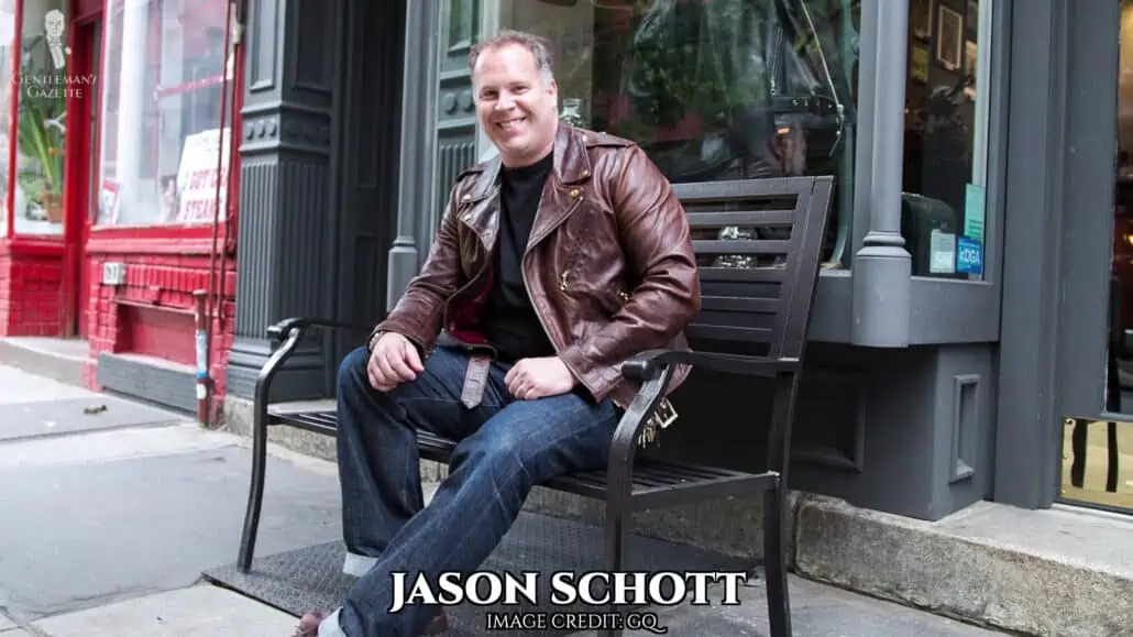 Jason Schott COO and grandson of the founder sitting on a bench wearing a perfecto jacket