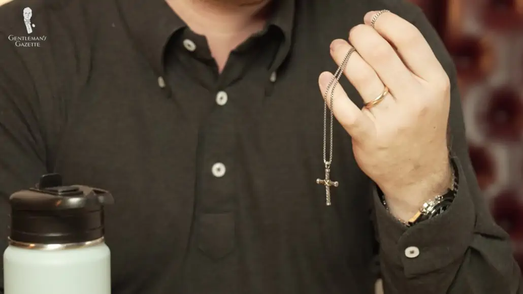 Nathan's necklace with a cross pendant is a gift from his wife. 
