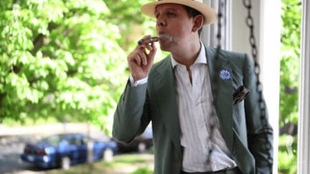 Raphael enjoys a cigar while wearing a summer ensemble