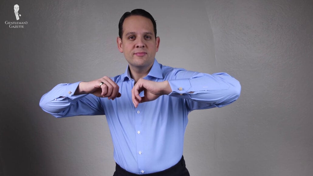 Raphael wearing a blue dress shirt with double cuffs.