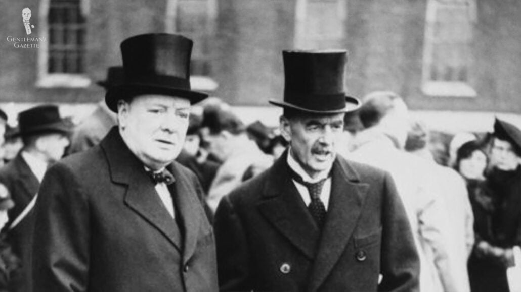 Two gentlemen wearing a top hat.