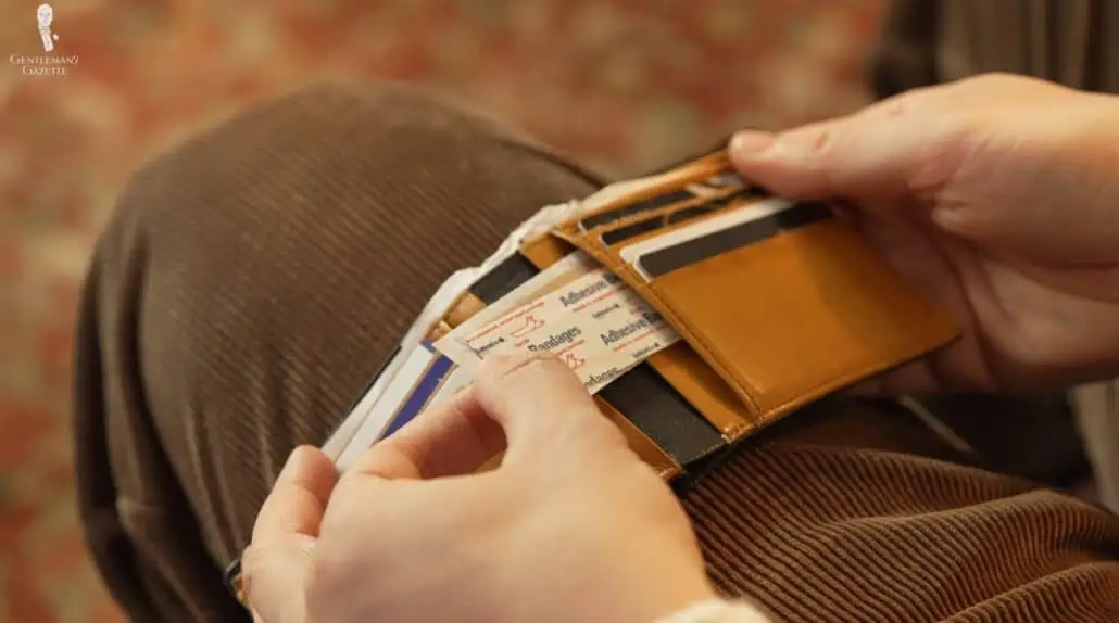 A wallet can store more than just cash; here, Raphael stashes some adhesive bandages in his wallet.