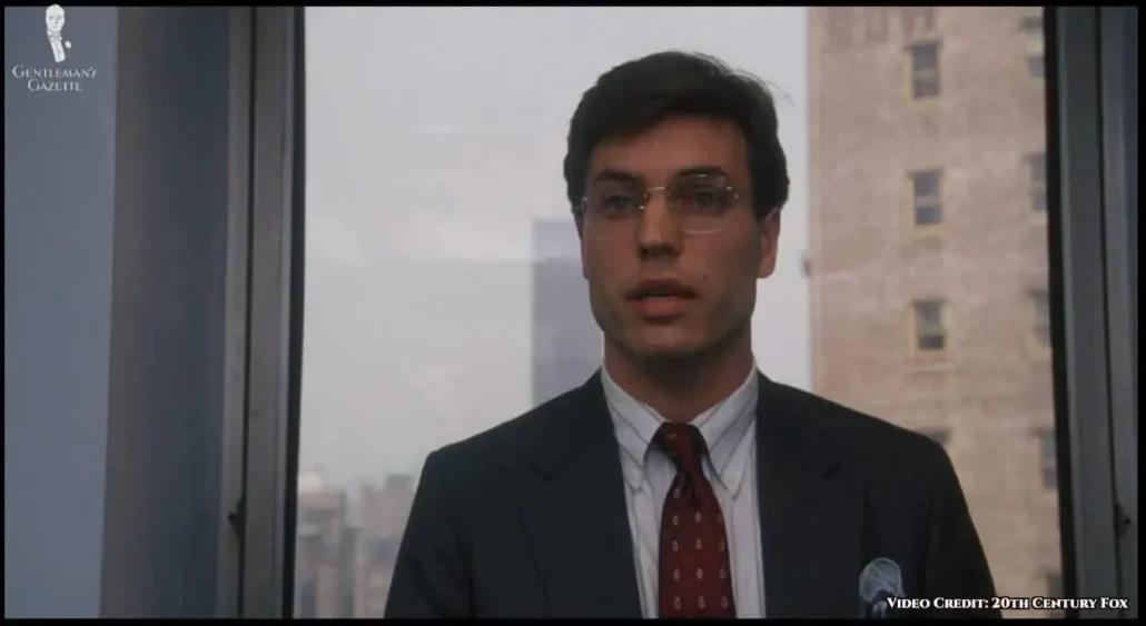 One of the government agents in a pair of rimless octagon eyeglasses.