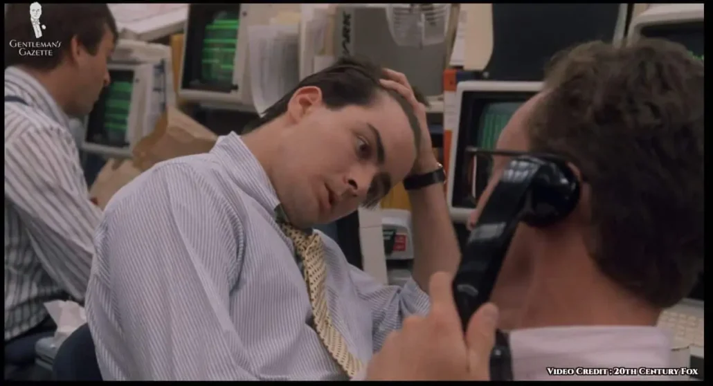 Fox in a vertically striped shirt and yellow tie.