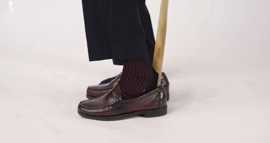 The shoe horn in action; Midnight Blue and Burgundy Shadow Stripe Ribbed Socks and Luxury Shoe Horn with Long 25" Handle from Fort Belvedere