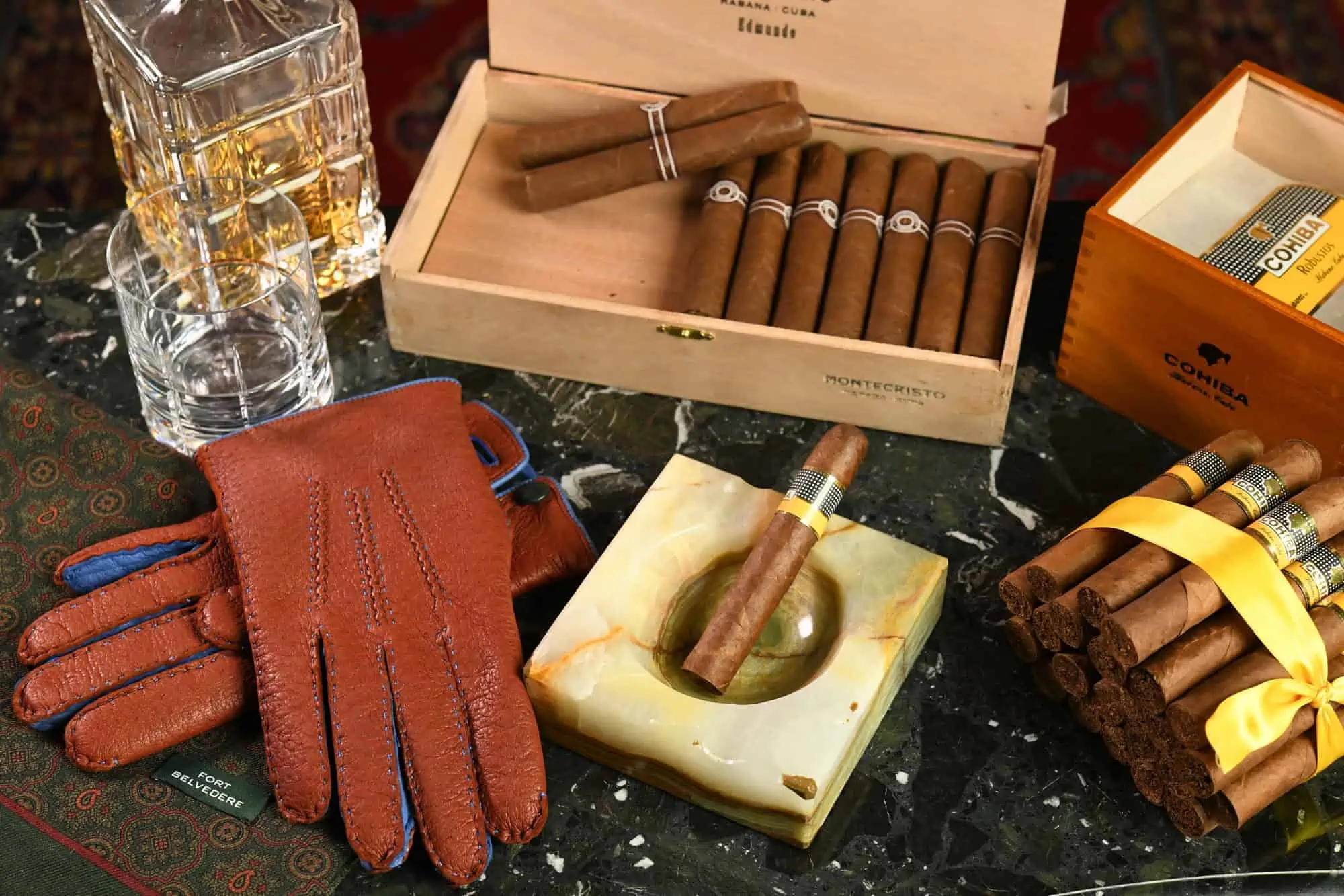 Gloves, scarf, cigars, whiskey assorment of gentlemanly accessories
