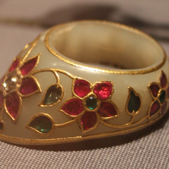 A photograph of a heavily decorated gold ring