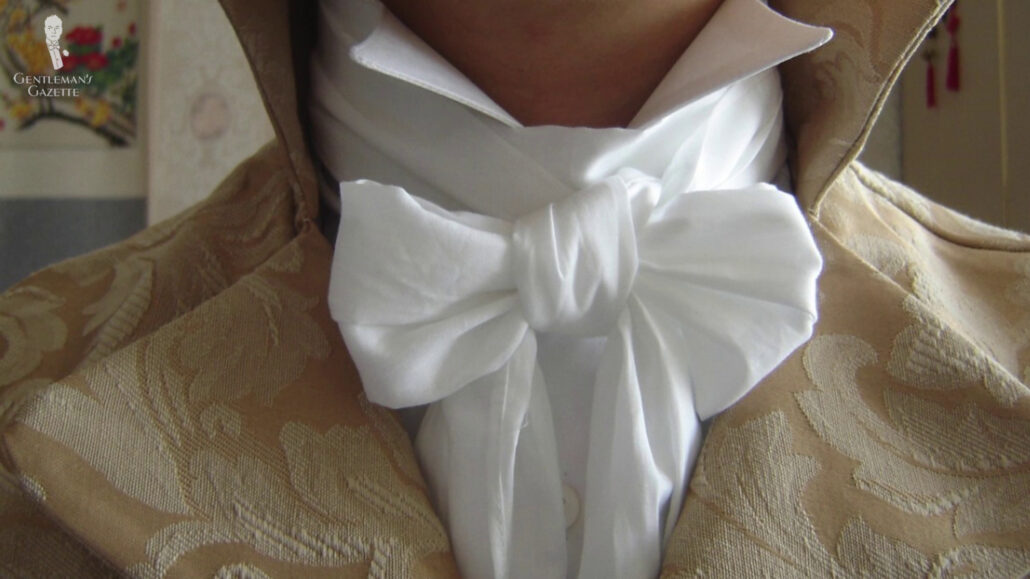 A cravat tied like a bow tie which helped tall collars in the 1800s to stand up more proudly.