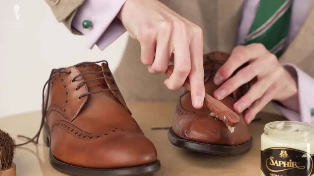 Brown shoes that are being polished.