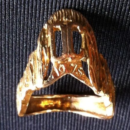 A gold class ring in a unique design 