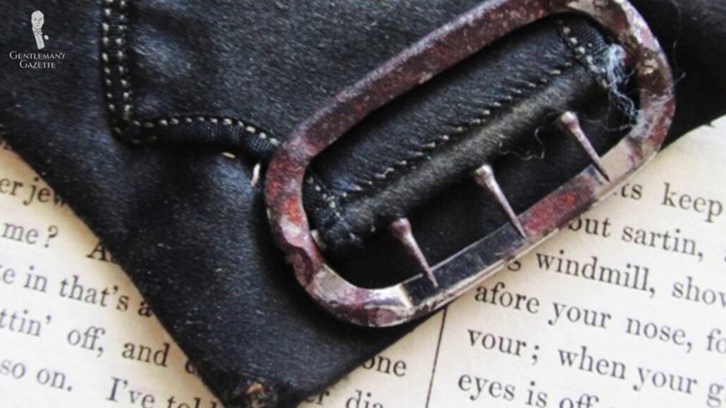 One of the earliest types of buckles where the other end would be threaded through then secured.