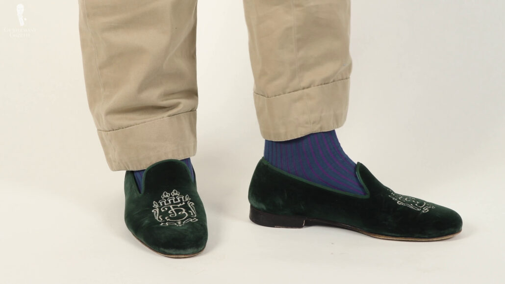 Raphael’s green velvet slippers paired with shadow striped socks in teal and purple from Fort Belvedere.