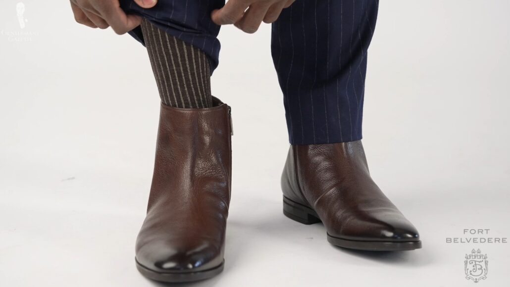The Indochino navy striped suit trousers matched with a pair of brown Chelsea boots and Fort Belvedere shadow-striped socks.