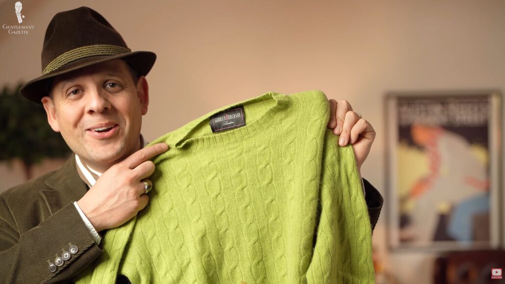 Raphael shows the second mystery item: a chartreuse green cashmere sweater