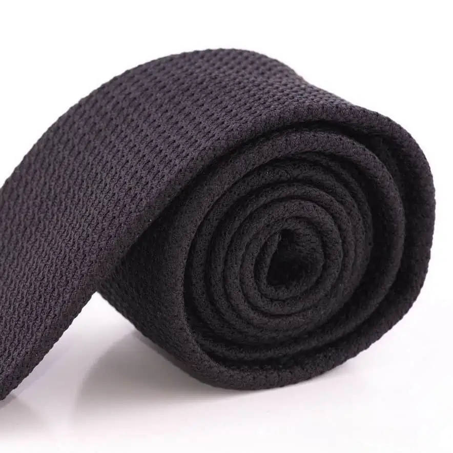 A rolled up Black grenadine tie