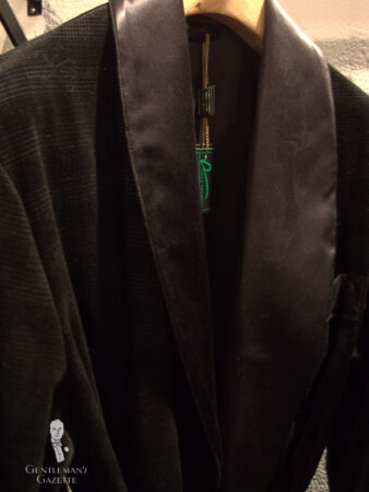 A photograph of a dark green smoking jacket