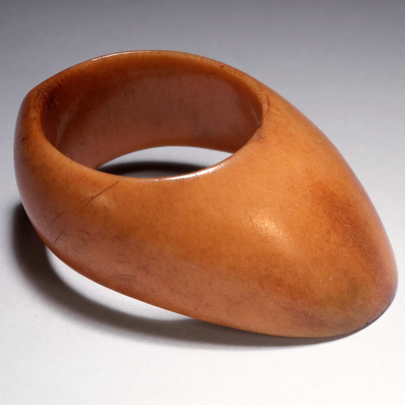 A photograph of a plain, oblong thumb ring