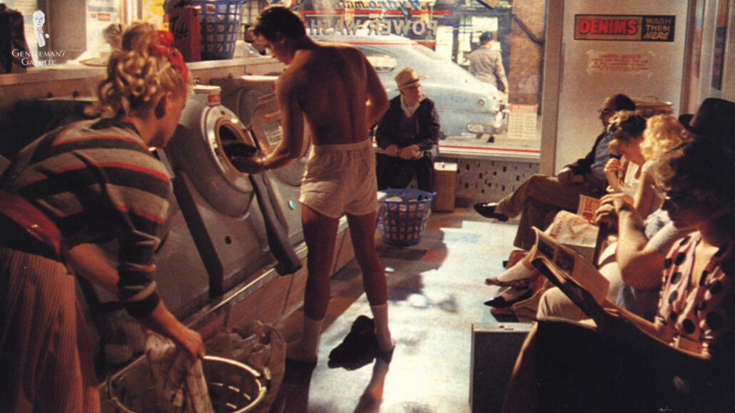 Nick Kamen wearing his Sunspel boxers while doing laundry.