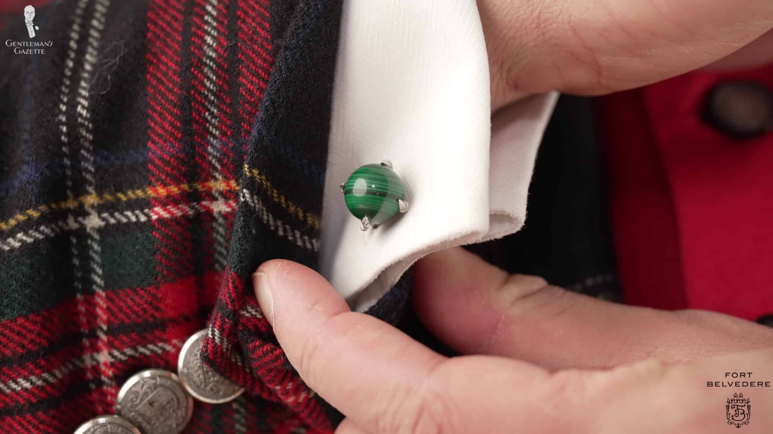 Raphael's silver and malachite cufflinks and green pinky ring pick up on the Christmas theme.