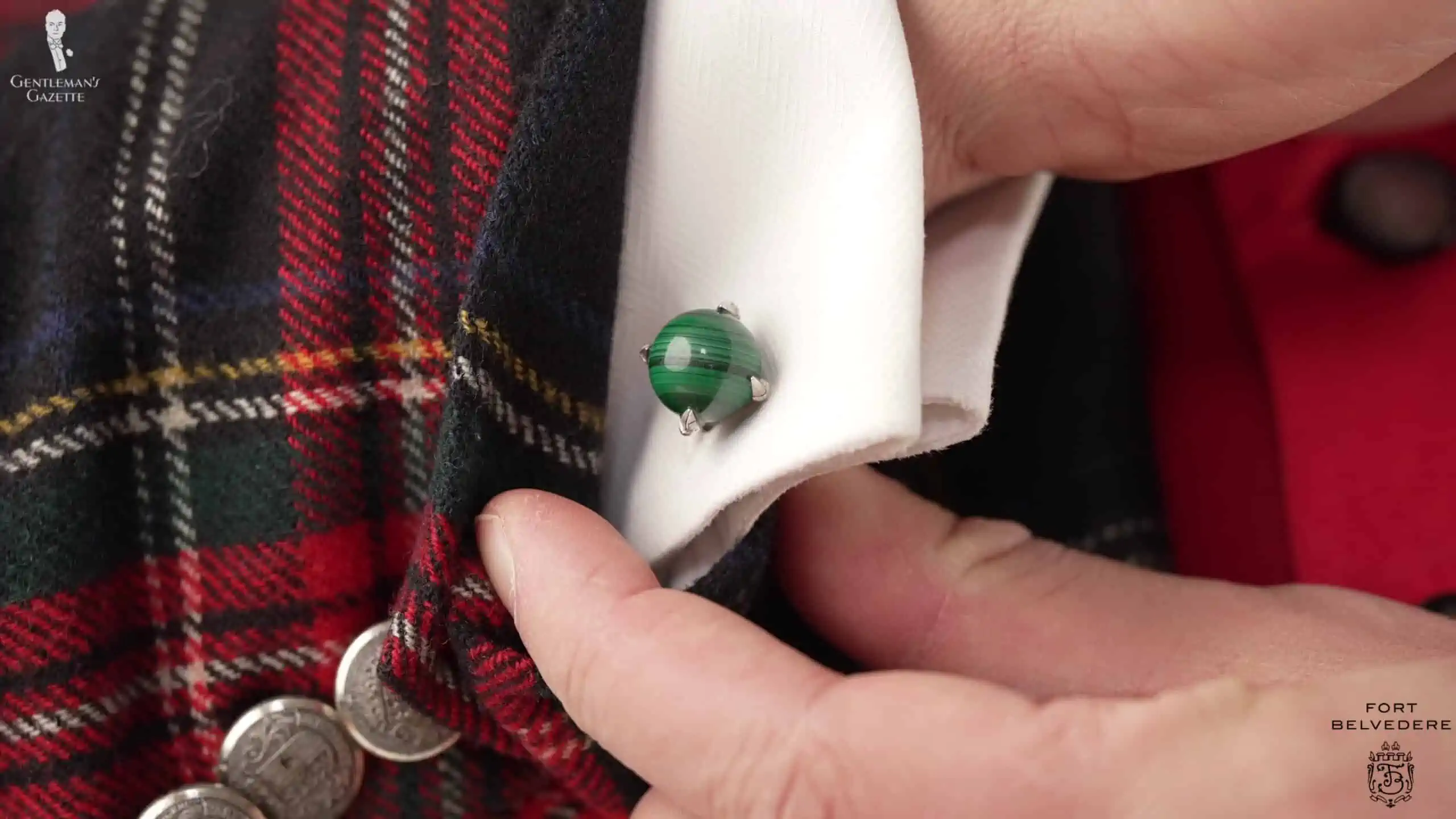 Raphael's silver and malachite cufflinks and green pinky ring pick up on the Christmas theme.