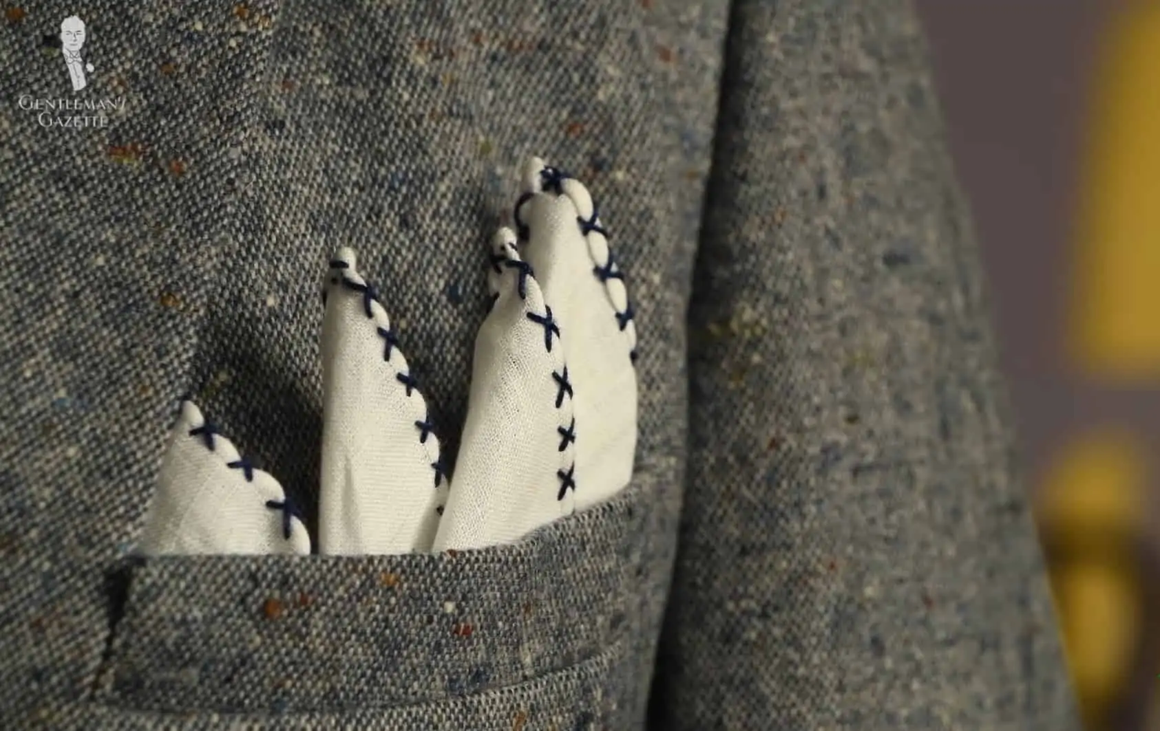 A White Linen Pocket Square with Navy Blue Hand-rolled X Stitch from Fort Belvedere